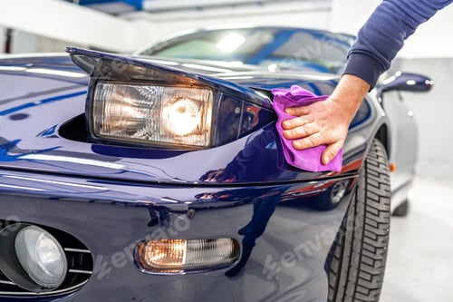 Preview: detailing and polishing the body of a luxury sports car using a micro fiber. flip up car light