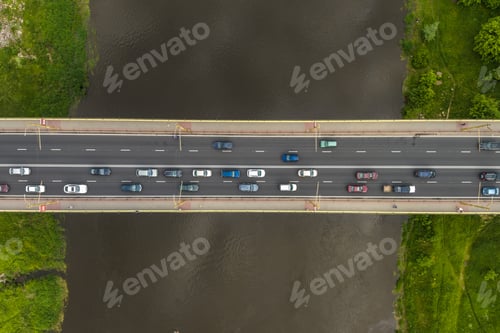 Preview: aerial view on heavy traffic on a bridge with a wide multi-lane road across a wide river