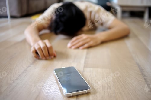 Preview: Young Asian Man With Smartphone Fainted on The Floor at Home