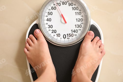 Preview: Woman standing on floor scales indoors, top view. Overweight problem