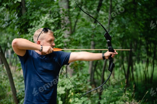 Preview: Archer man training with the bow in the forest