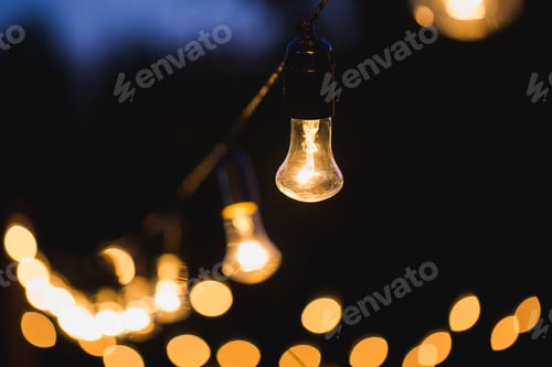 Preview: outdoor string lights hanging on a line in backyard