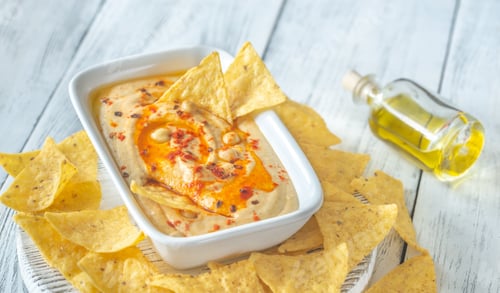 Preview: Bowl of hummus on the wooden table