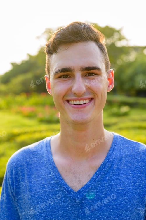 Preview: Young handsome man relaxing at the park