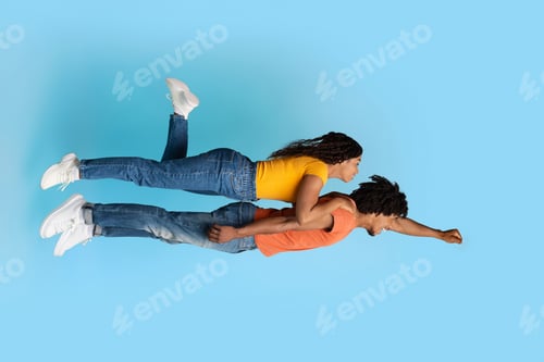 Preview: Romantic african american couple flying together in the air