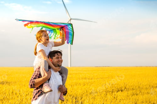 Preview: Father and daughter having fun, playing with kite together on the Wheat Field on Bright Summer day
