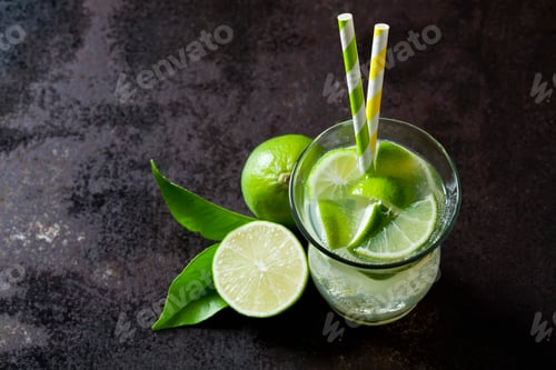 Preview: Fruit spritzer of limes in a glass with drinking straws