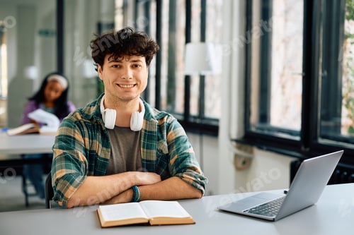Preview: Happy university student in the classroom looking at camera.