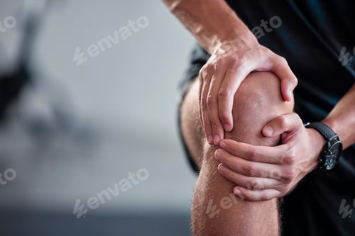 Preview: Hands, knee and pain with a sports man holding a joint injury while training in a gym for health. F