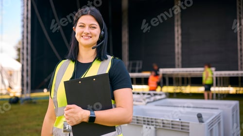 Preview: Portrait Of Female Production Worker Setting Up Outdoor Stage For Music Festival Or Concert