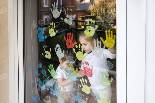 Preview: The kids paint with palms on the window. Quarantine