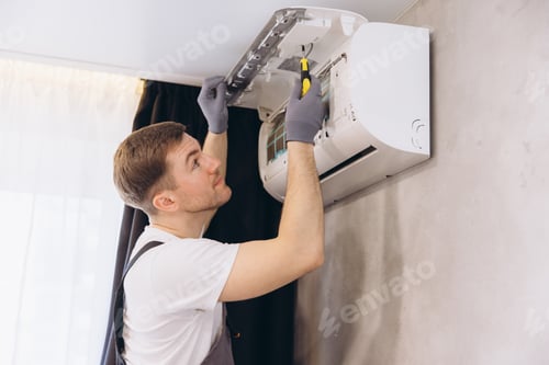 Preview: Professional plumber repairing modern air conditioner unit