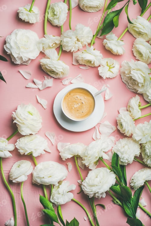 Preview: Flat-lay of cup of coffee surrounded with white ranunculus flowers