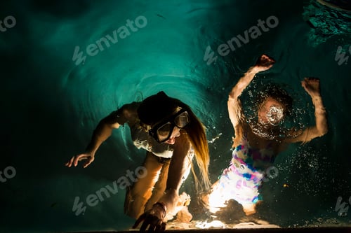 Preview: Two children swimming in pool at night