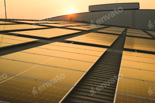 Preview: Photovoltaic solar panels on rooftop with sunset at solar cell farm