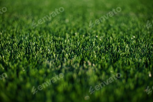 Preview: green synthetic grass surface on a soccer ground, european football field with artificial grass