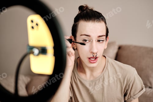 Preview: Gay man applying make-up while recording a online video
