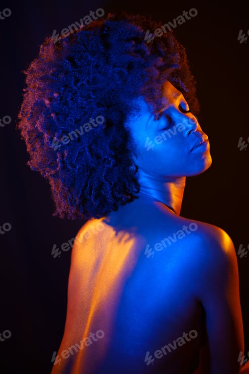 Preview: Naked African American model under neon illumination