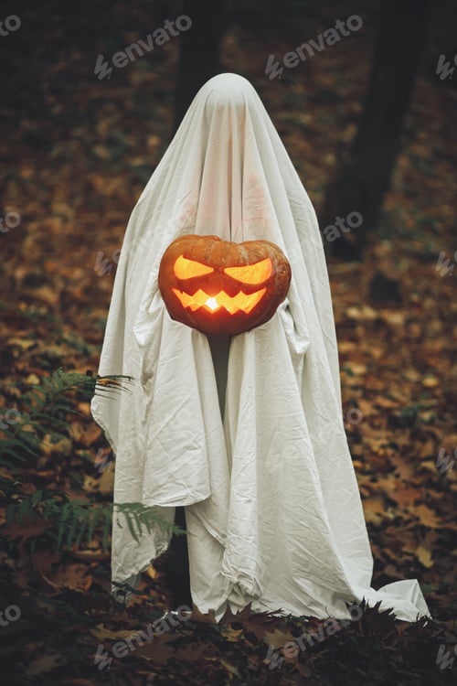 Preview: Happy Halloween! Spooky ghost holding glowing jack o lantern in moody dark autumn forest