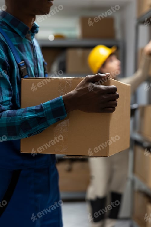 Preview: African american worker in logistics center manages product delivery