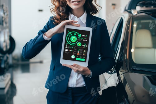 Preview: partial view of businesswoman holding digital tablet with graphs and charts on screen
