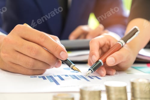 Preview: Male and female office workers analyze data graphs,Male and fema