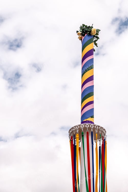 Preview: Coloured ribbons hanging from a traditional English Maypole on May Day.