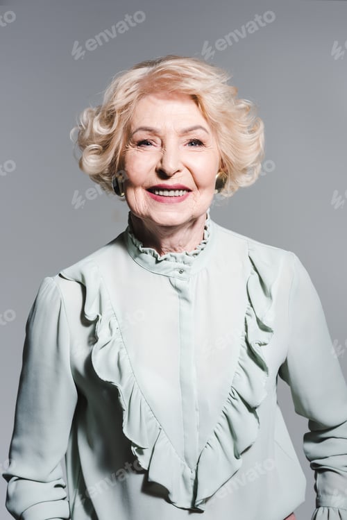 Preview: close-up portrait of smiling senior woman isolated on grey