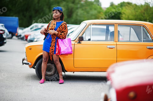Preview: African american lady near orange classic retro car