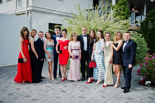 Preview: Group of good-looking graduates posing on the graduation day next to the restaurant.