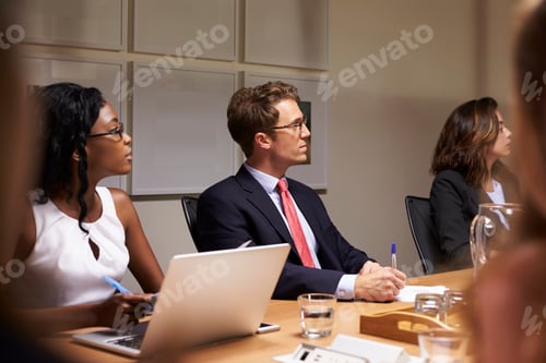 Preview: Business colleagues listening at boardroom meeting