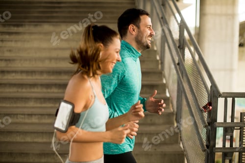 Preview: Young couple running in urban enviroment
