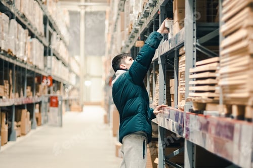 Preview: A young guy takes out goods from the counter in the store.