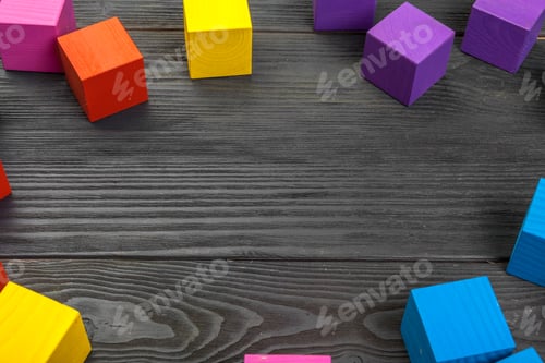 Preview: colorful wooden cubes on wooden table creative photo.