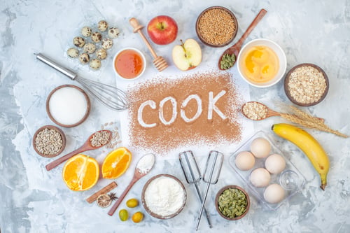 Preview: Top view of raw oatmeal cook writing fresh fruits spikes and eggs on ice background