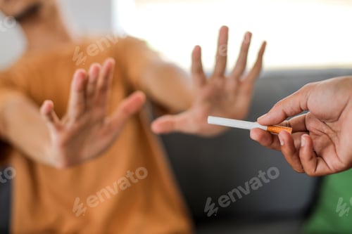 Preview: Close up hands of a man refusing to smoke cigarette.