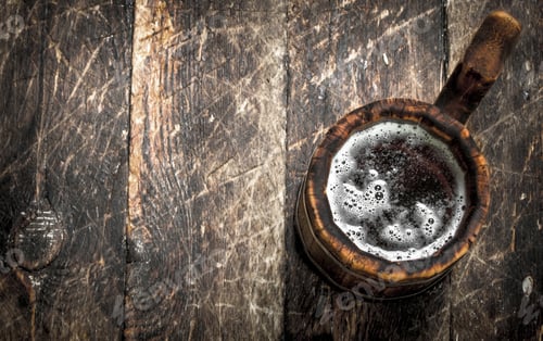 Preview: Fresh beer in a wooden mug.