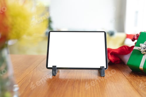 Preview: Tablet with copy space on screen lying on table with christmas decorations