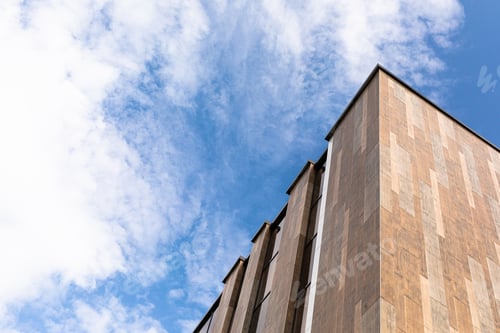 Preview: A large and tall gray house against the sky