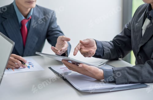 Preview: Business people meeting analyzing financial documents at meeting.