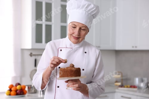 Preview: Professional pastry chef making cake in kitchen