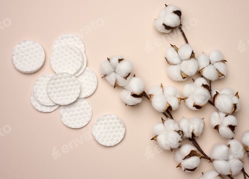 Preview: White cotton sponges on beige background. Design for the beauty, medicine and cosmetics industry