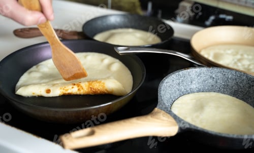 Preview: Russia Moscow 14.03.2021 Cooking many big tasty pancakes Lot of pans,oil,pancake dough.Russian