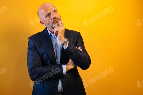 Preview: A man with a beard and a blue suit is thinking