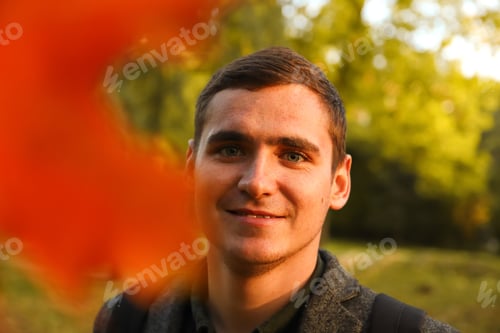 Preview: portrait young man on nature autumn background. Smiling young man. 20s years. Handsome man outdoors