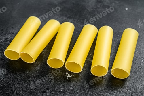 Preview: Raw cannelloni pasta. Italian cuisine. Black background. top view