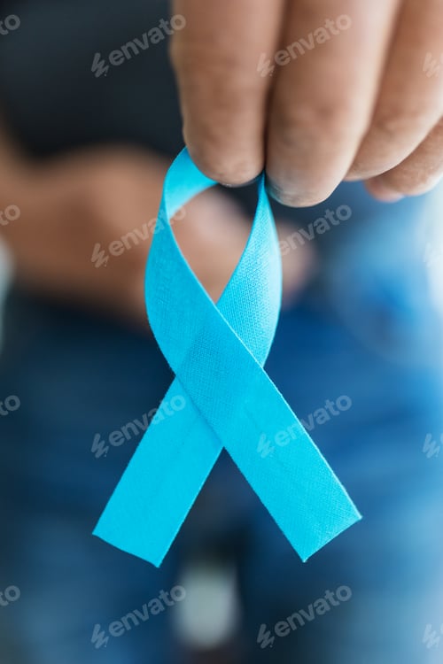 Preview: Senior man holding a blue cancer awareness ribbon