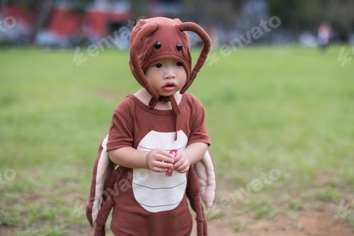 Preview: Toddler in Halloween cockroach outfit on lawn