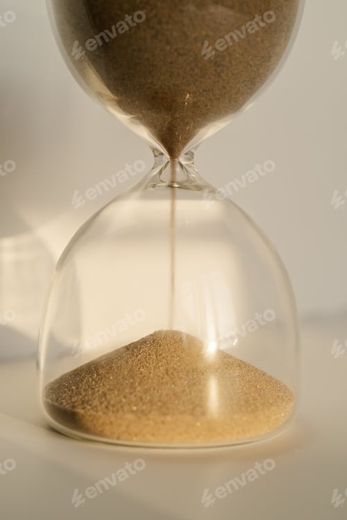Preview: Transparent hourglass on a white sunny background.