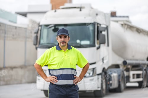 Preview: Confident male mechanical engineer standing near truck